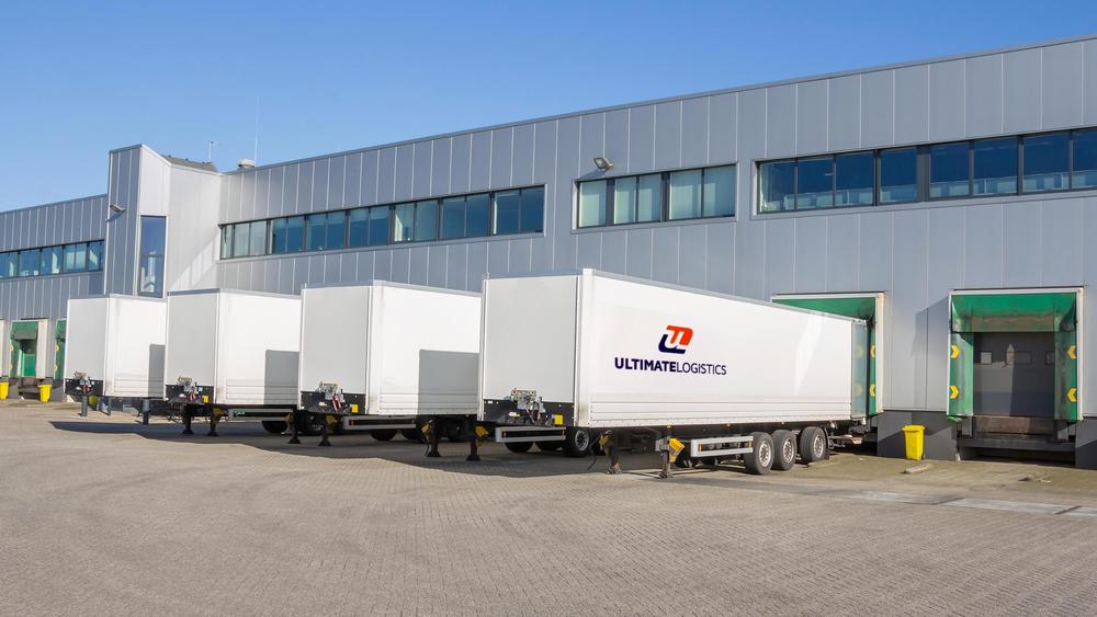 Ultimate Logistics trailers backed into a distribution center loading bay